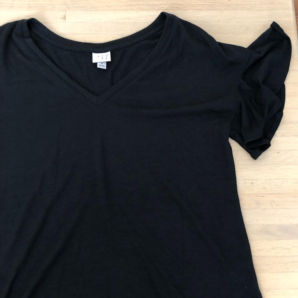 Black shirt with ruffle sleeves. Never worn